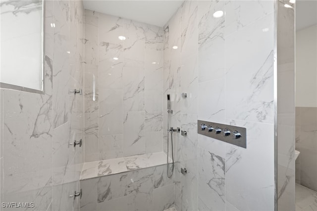 bathroom with a tile shower