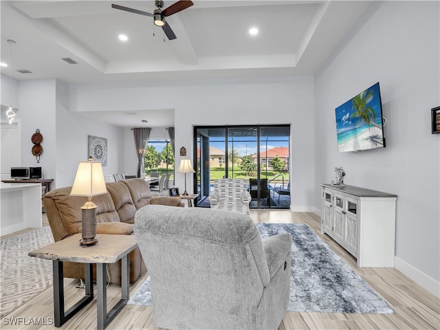 living room with light hardwood / wood-style floors and ceiling fan