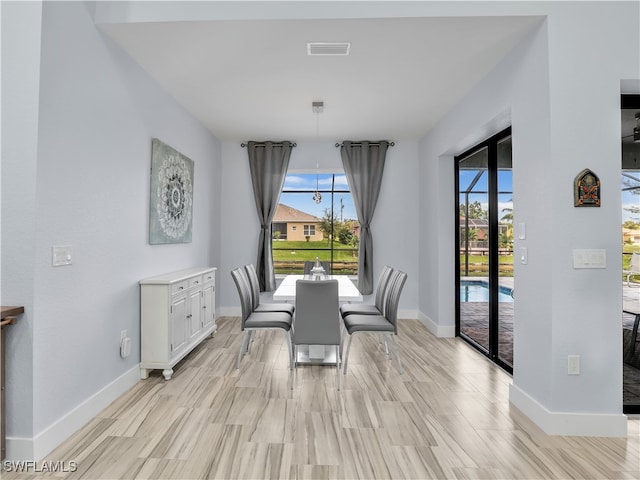 dining space with light wood-type flooring