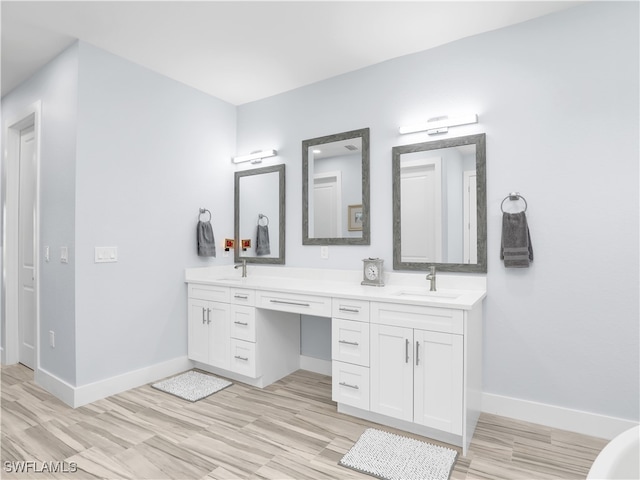 bathroom with vanity and hardwood / wood-style flooring