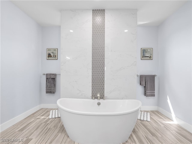 bathroom with a bathtub and wood-type flooring