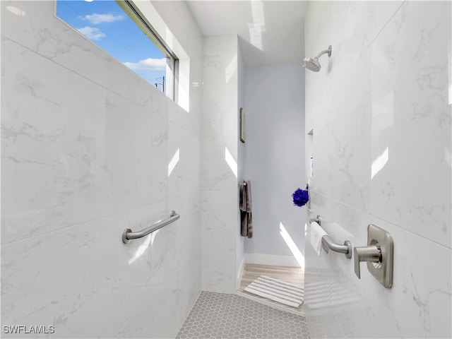 bathroom with tiled shower