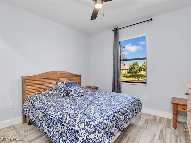 bedroom with ceiling fan and hardwood / wood-style floors