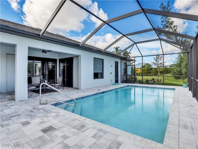 view of pool with a lanai, a patio area, and ceiling fan