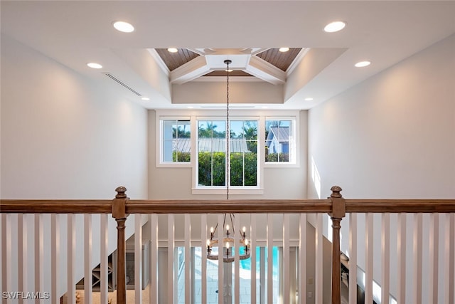 room details with coffered ceiling, beam ceiling, crown molding, and a notable chandelier