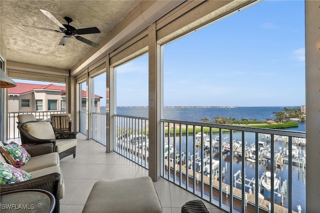 balcony featuring ceiling fan and a water view