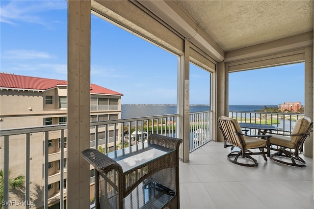 sunroom / solarium with a water view