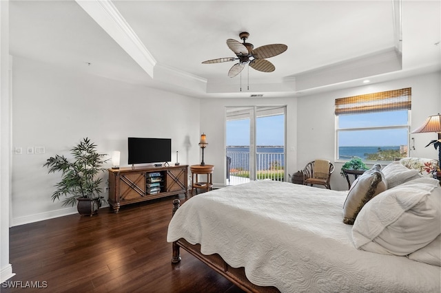 bedroom with a raised ceiling, access to exterior, ceiling fan, and dark wood-type flooring