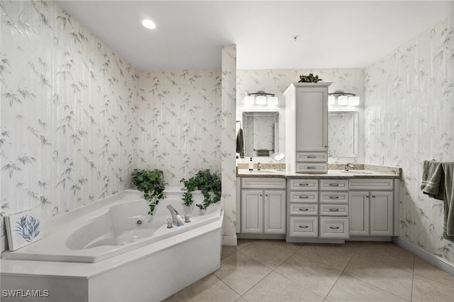 bathroom featuring tile patterned flooring, vanity, and a tub