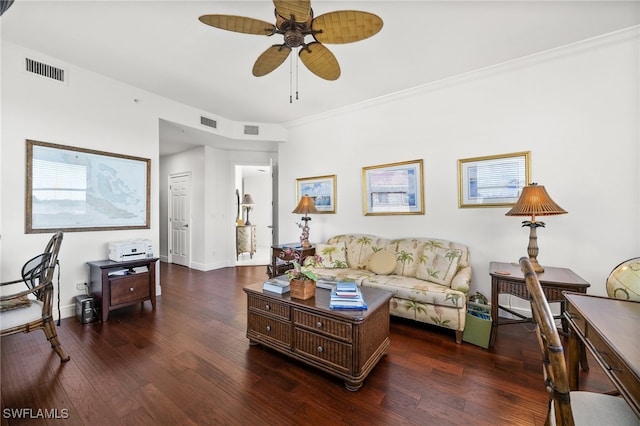 living room featuring dark hardwood / wood-style flooring, ceiling fan, and crown molding