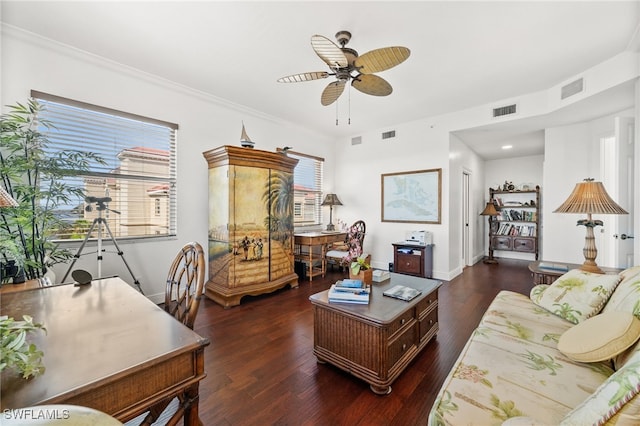 living room featuring plenty of natural light, ceiling fan, and dark wood-type flooring