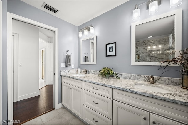 bathroom featuring vanity, tile patterned floors, and walk in shower