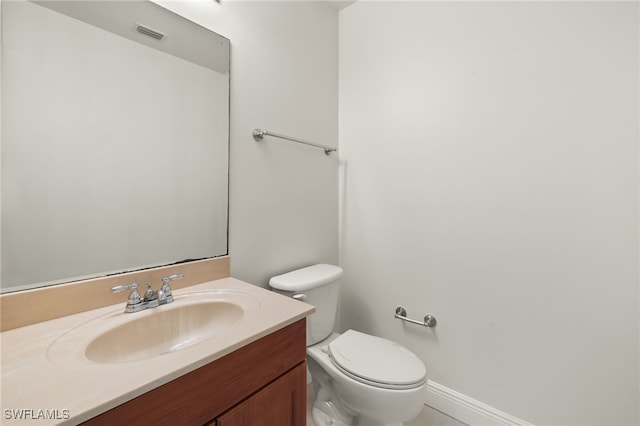 bathroom with toilet and vanity