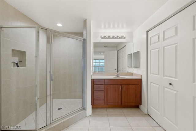 bathroom with vanity, tile patterned flooring, and an enclosed shower