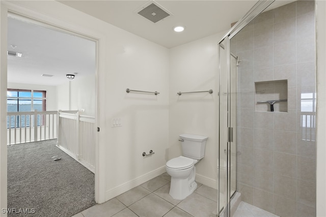 bathroom with toilet, walk in shower, and tile patterned flooring