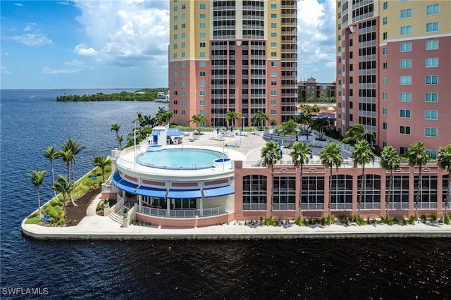 exterior space featuring a community pool and a water view