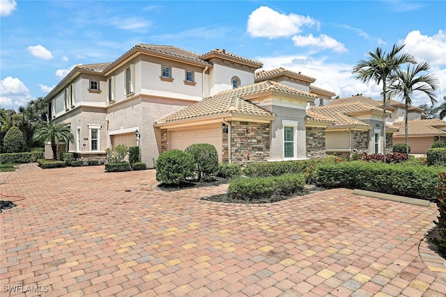 mediterranean / spanish-style home featuring a garage