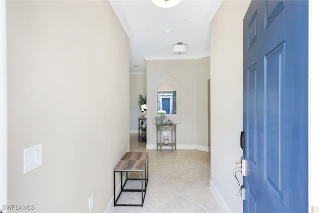 tiled entryway featuring ornamental molding