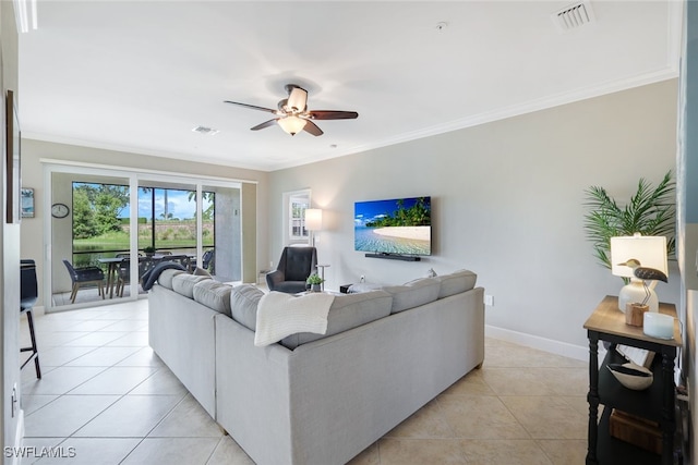 tiled living room featuring ceiling fan and crown molding