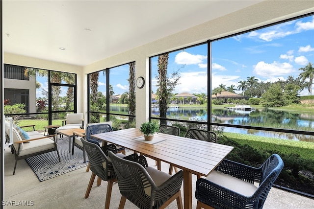 sunroom with a wealth of natural light and a water view