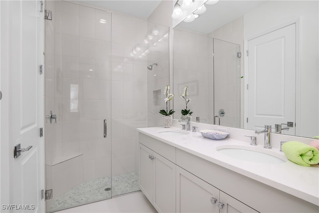 bathroom with vanity and a shower with door