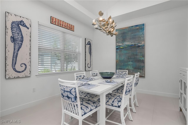 tiled dining area featuring a chandelier