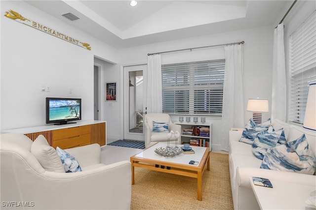 carpeted living room with lofted ceiling