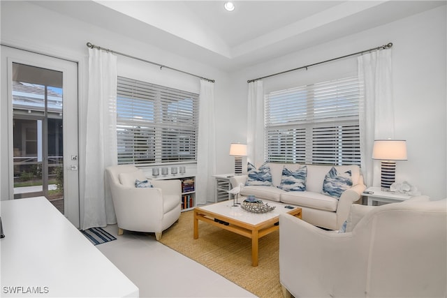 living room featuring a healthy amount of sunlight and lofted ceiling