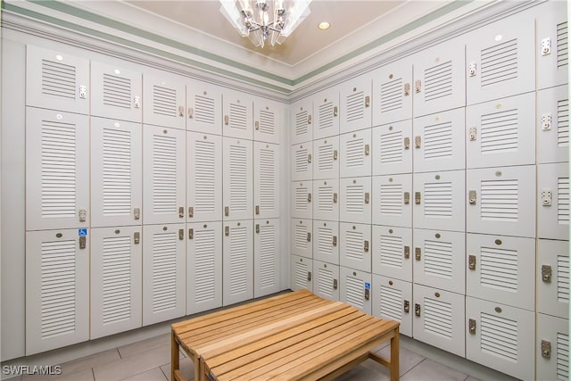 spacious closet featuring light tile patterned floors and a notable chandelier