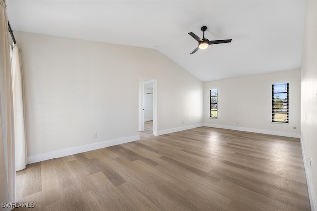 unfurnished room with ceiling fan, light wood-type flooring, and vaulted ceiling