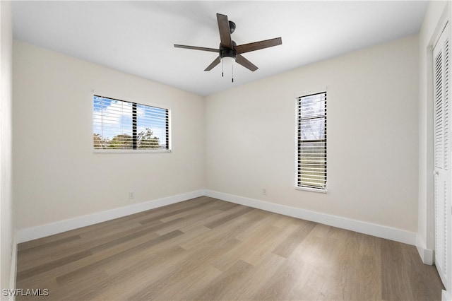 unfurnished bedroom with ceiling fan, a closet, and light hardwood / wood-style floors