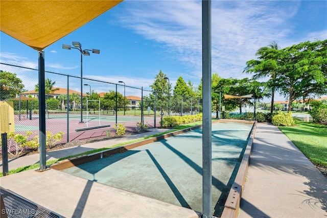 view of property's community featuring tennis court