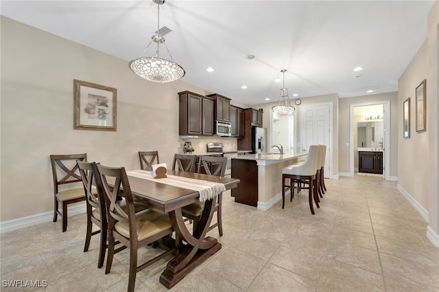 tiled dining room with sink