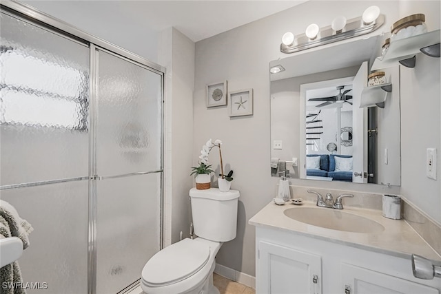 bathroom featuring ceiling fan, a shower with shower door, vanity, and toilet