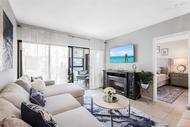 living room featuring a fireplace and light tile patterned floors