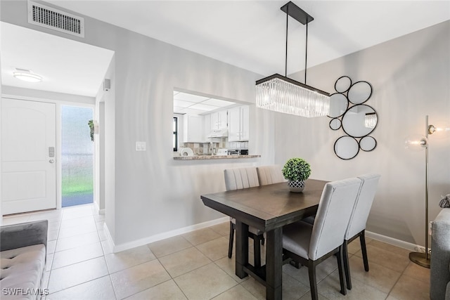 807 River Point Dr Unit 102D, Naples, FL 34102 - dining area with baseboards, visible vents, light tile patterned floors, and an inviting chandelier