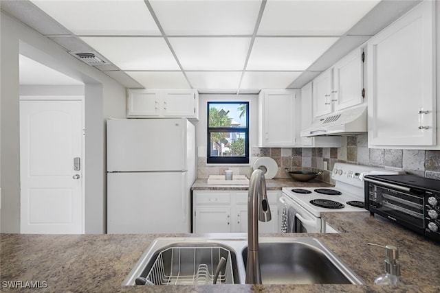 kitchen with white cabinets, premium range hood, sink, white appliances, and a drop ceiling