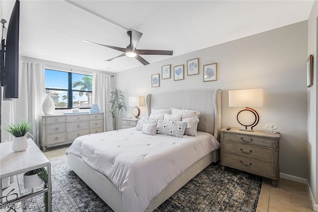 tiled bedroom featuring ceiling fan