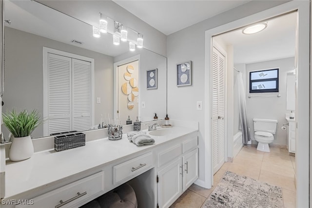 bathroom featuring tile patterned floors, vanity, and toilet