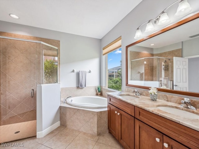 bathroom featuring plus walk in shower, tile patterned floors, and vanity