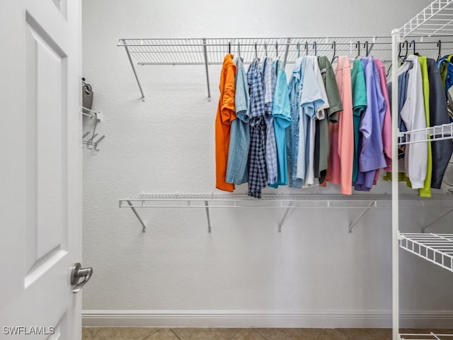 spacious closet featuring tile patterned flooring