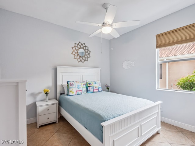 bedroom with ceiling fan and light tile patterned floors