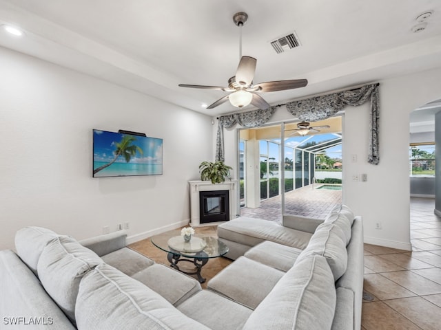 living room featuring ceiling fan and light tile patterned flooring