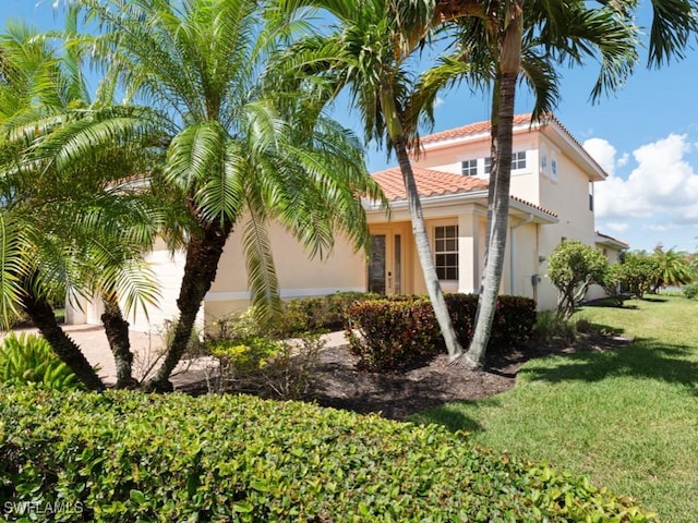 view of home's exterior with a lawn