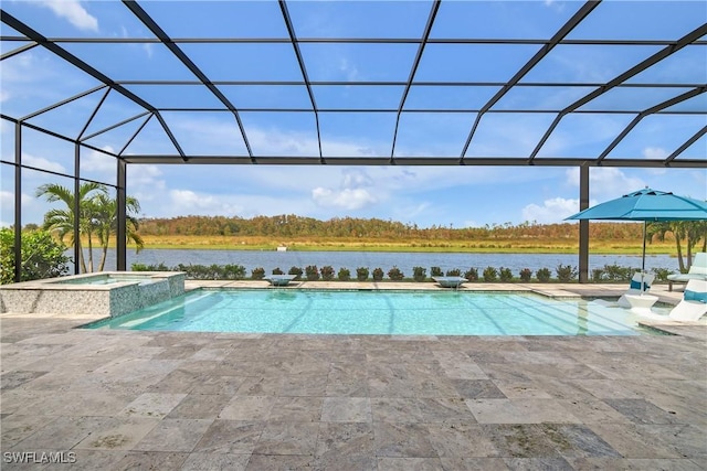 view of pool featuring glass enclosure, an in ground hot tub, and a patio area