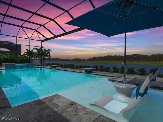 pool at dusk featuring a patio, a water view, and glass enclosure