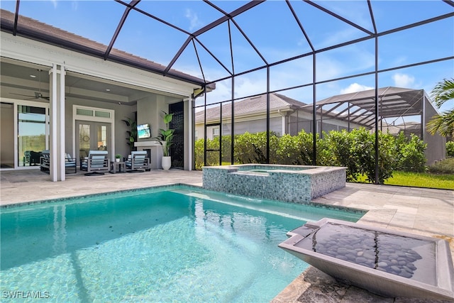 view of pool with french doors, pool water feature, ceiling fan, an in ground hot tub, and a patio