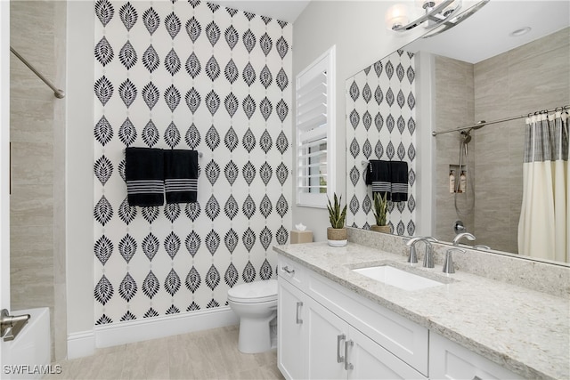 full bathroom with shower / bath combo with shower curtain, vanity, and toilet