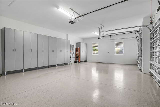 garage with electric panel and a garage door opener