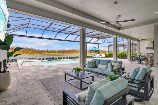 view of patio / terrace with an outdoor living space, ceiling fan, a water view, and glass enclosure